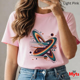 Person wearing a pink t-shirt with a colorful butterfly design, holding a phone.