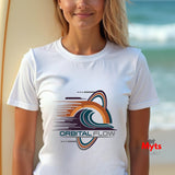 Person wearing a white t-shirt with 'Orbital Flow' design at the beach