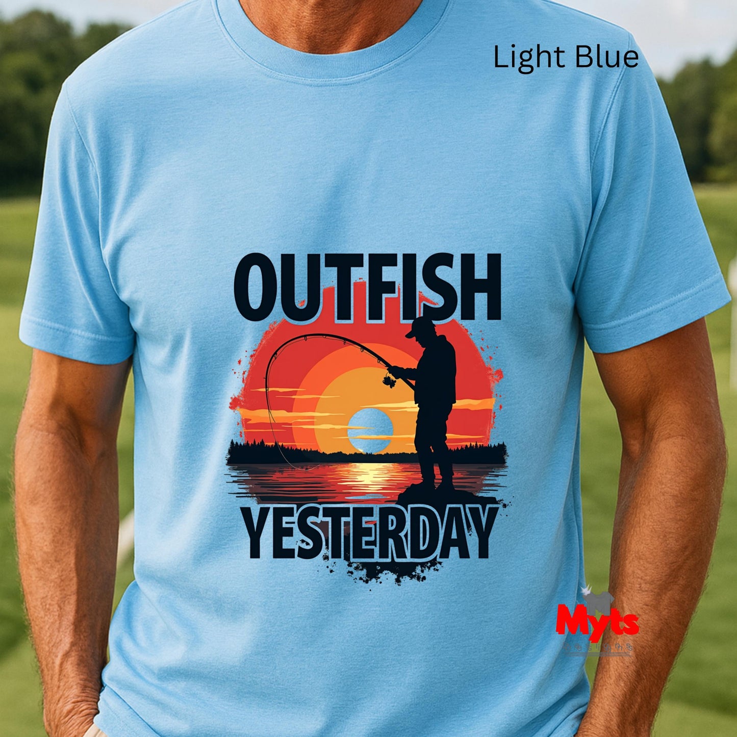 Light blue t-shirt with a fishing graphic and text 'Outfish Yesterday' on a grassy background.