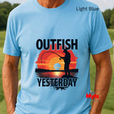 Light blue t-shirt with a fishing graphic and text 'Outfish Yesterday' on a grassy background.