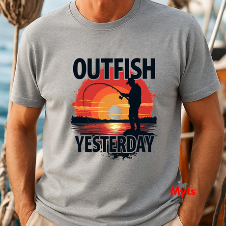 Gray t-shirt with 'Outfish Yesterday' design featuring a sunset and fishing silhouette, worn by a person on a boat.