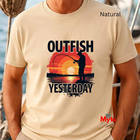 Natural t-shirt with 'Outfish Yesterday' design featuring a sunset and fishing silhouette, worn by a person on a boat.
