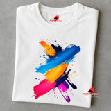 Folded white t-shirt with colorful abstract design on a gray background