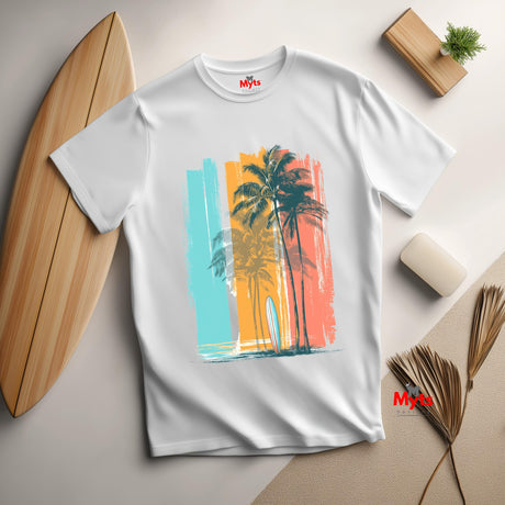 White t-shirt with a colorful palm tree design on a light surface with a surfboard and decor items.