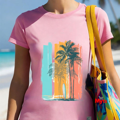 Person wearing a pink t-shirt with a palm tree and beach design, standing on a beach.
