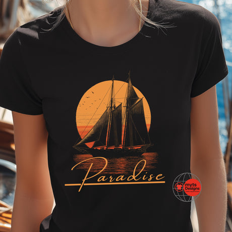 Black t-shirt with a sailboat and 'Paradise' design on an orange background