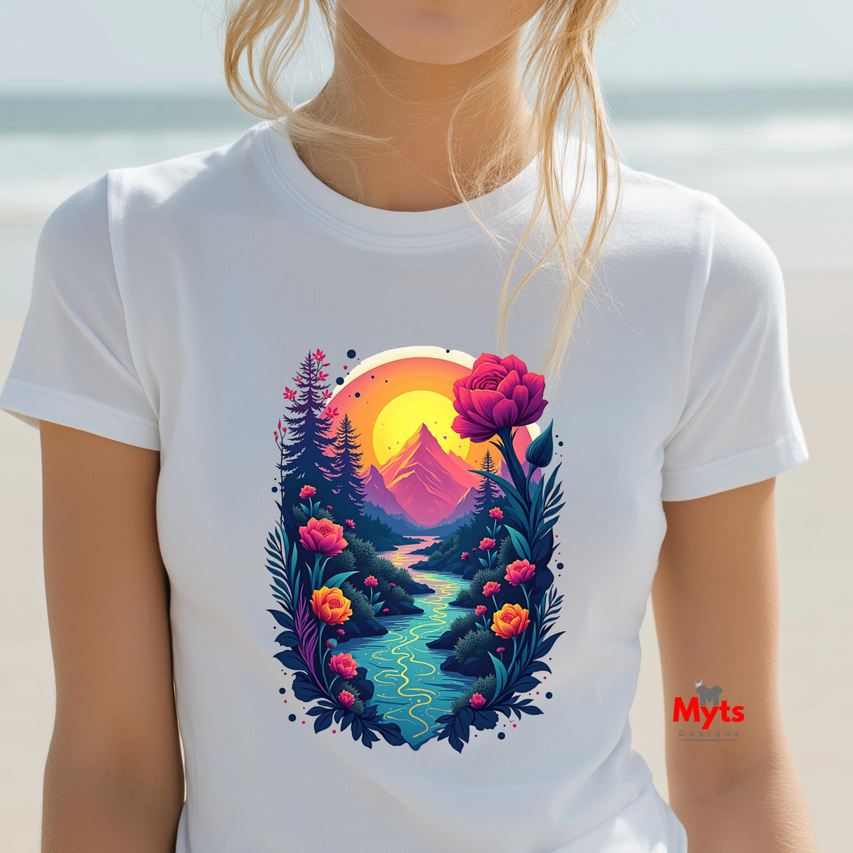 Person wearing a white t-shirt with a colorful nature graphic design featuring mountains, flowers, and a sunset.