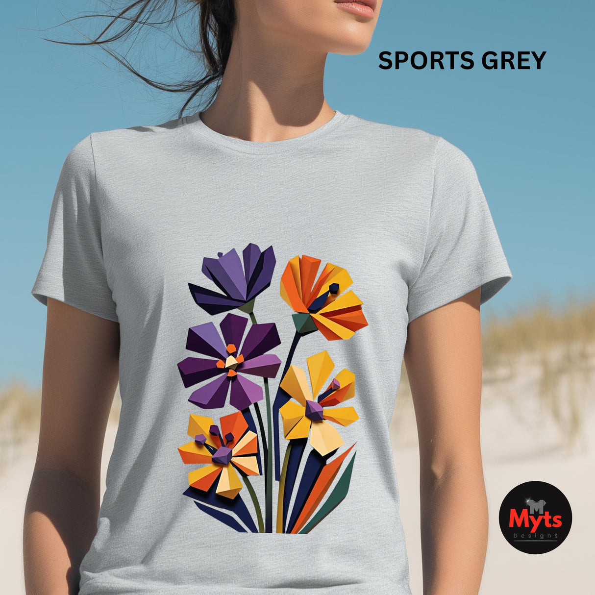 Woman wearing a Sports Grey geometric wildflower T-shirt featuring colourful abstract flowers in purple, orange, yellow, navy and green with angular modern petals.