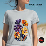 Woman wearing a Sports Grey geometric wildflower T-shirt featuring colourful abstract flowers in purple, orange, yellow, navy and green with angular modern petals.