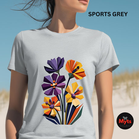 Woman wearing a Sports Grey geometric wildflower T-shirt featuring colourful abstract flowers in purple, orange, yellow, navy and green with angular modern petals.