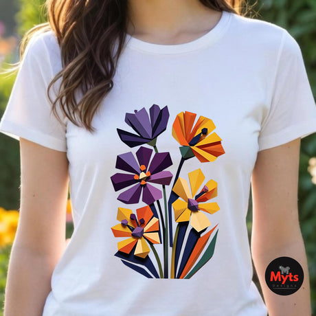 Woman wearing a white geometric wildflower T-shirt featuring colourful abstract flowers in purple, orange, yellow, navy and green with angular modern petals.