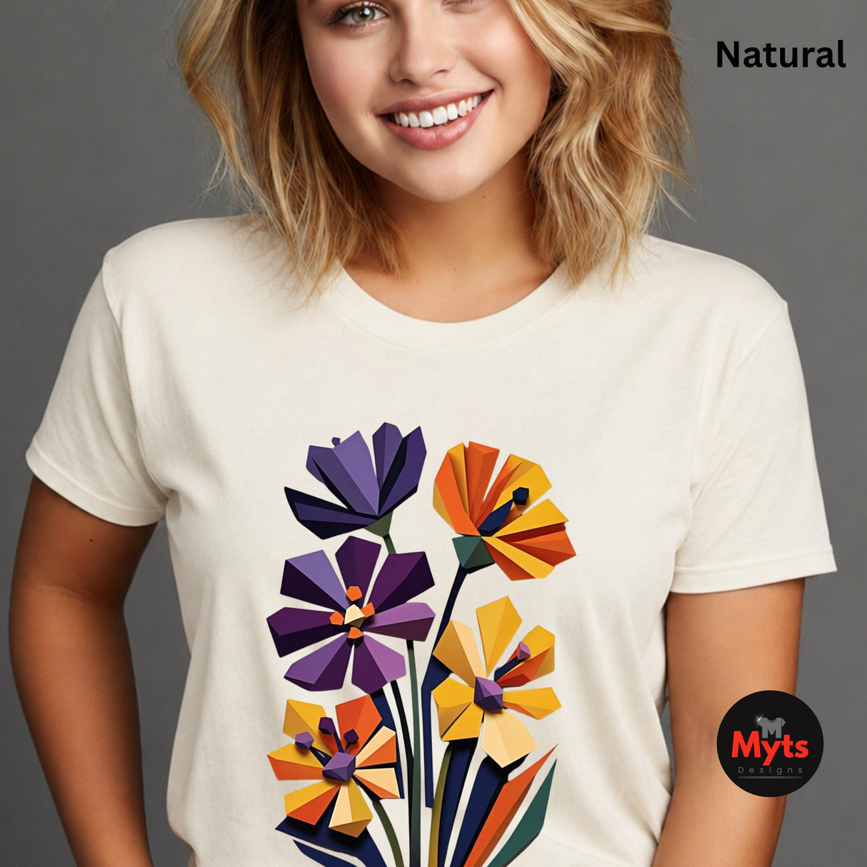 Woman wearing a Natural geometric wildflower T-shirt featuring colourful abstract flowers in purple, orange, yellow, navy and green with angular modern petals.