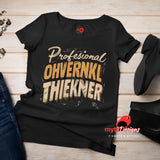 Black t-shirt with text design on a wooden surface, featuring the brand 'myts Designs'.