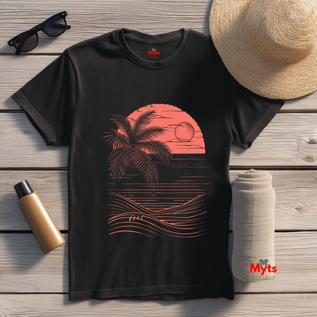 Black t-shirt with a red palm tree and sunset design, placed on a wooden surface with a hat, sunglasses, and bottle.