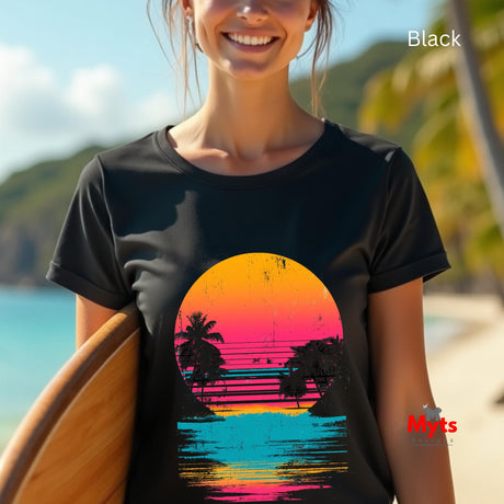 Person wearing a black t-shirt with a colorful sunset design on a beach.