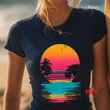 Person wearing a navy t-shirt with a colorful sunset design on a beach.