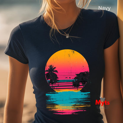 Person wearing a navy t-shirt with a colorful sunset design on a beach.