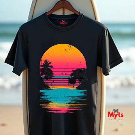 Black t-shirt with a colorful sunset design on a surfboard with a beach background