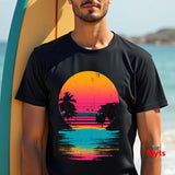 Person wearing a black t-shirt with a colorful sunset design on a beach.