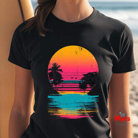 Person wearing a black t-shirt with a colorful sunset design on a beach.