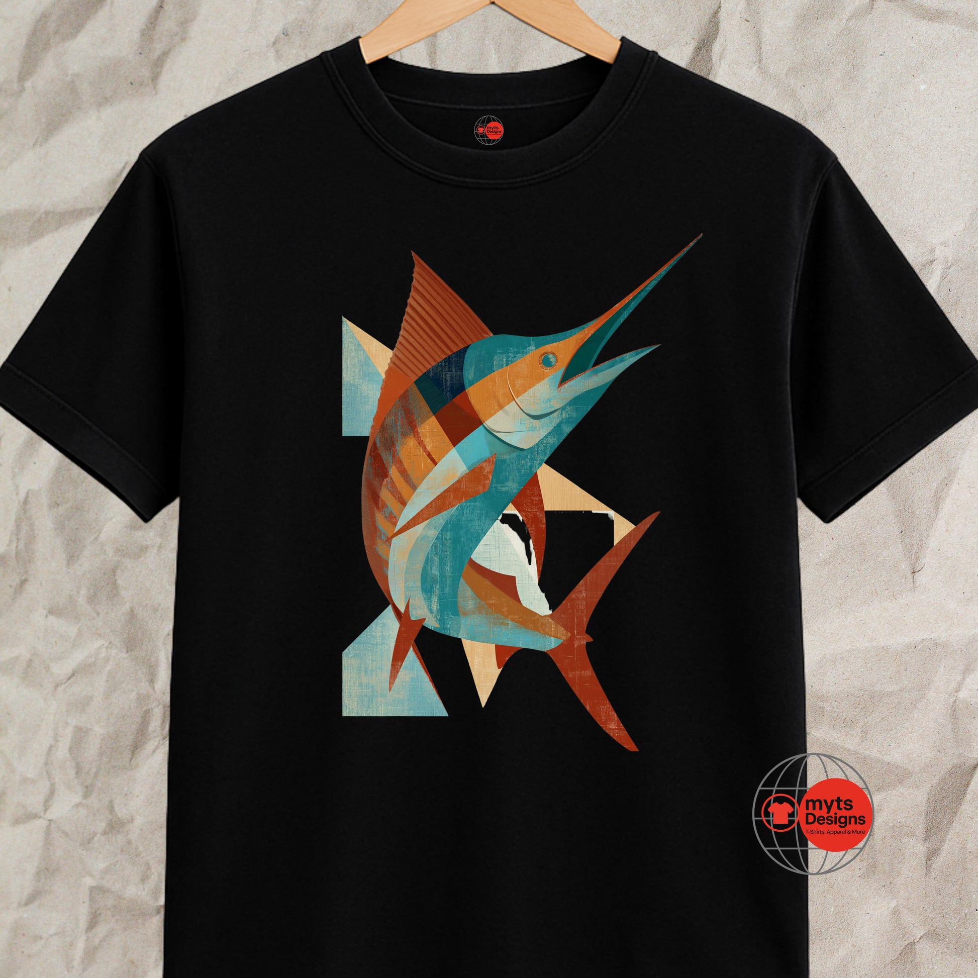Black t-shirt with a colorful fish design on a textured gray background