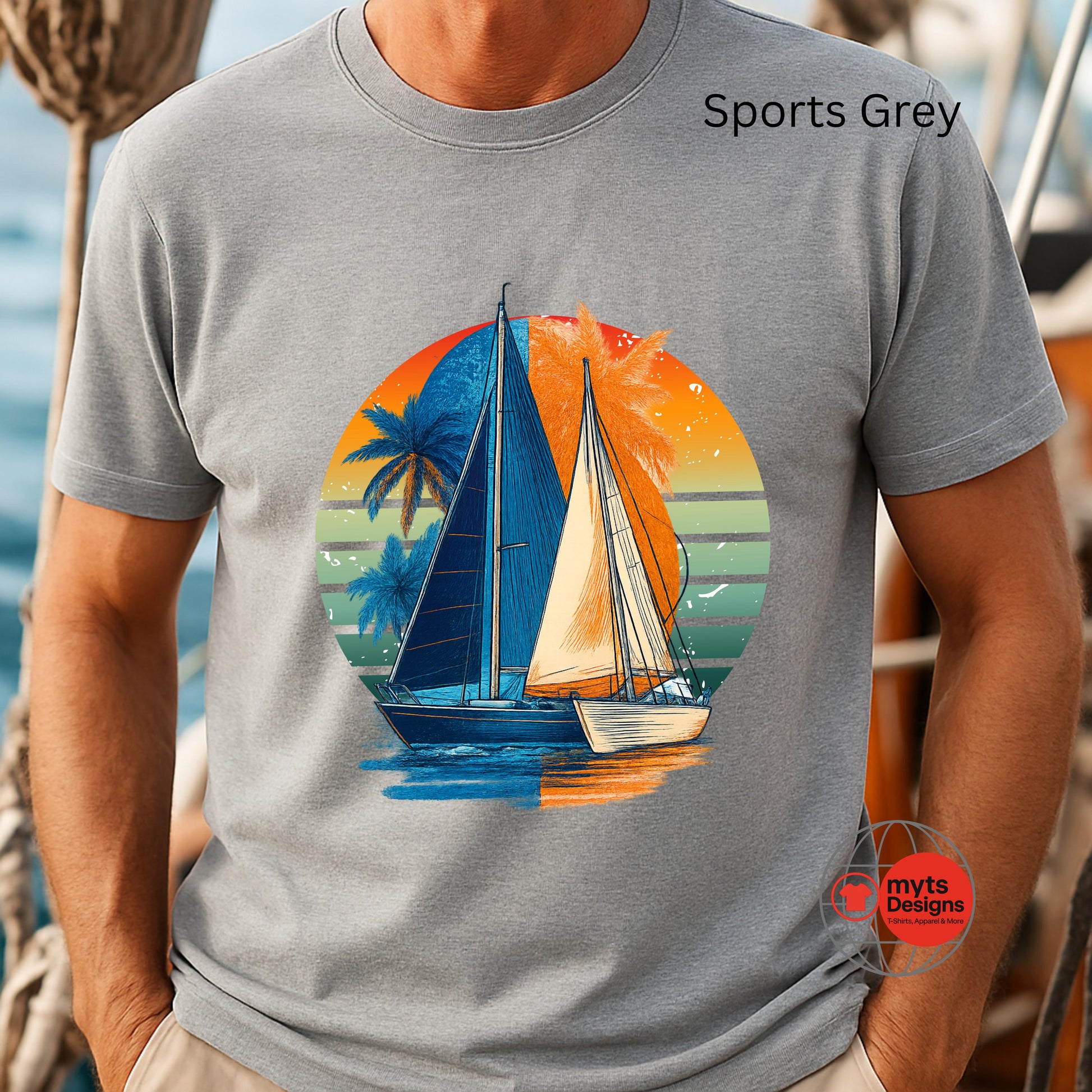 Person wearing a gray t-shirt with a sailboat graphic design.