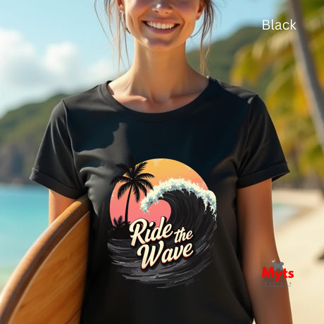 Person wearing a black t-shirt with 'Ride the Wave' design on a beach
