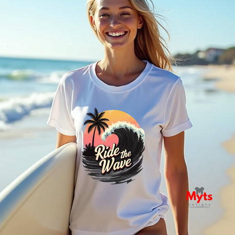 Woman wearing a white t-shirt with a wave design and 'Ride the Wave' text, standing on a beach.