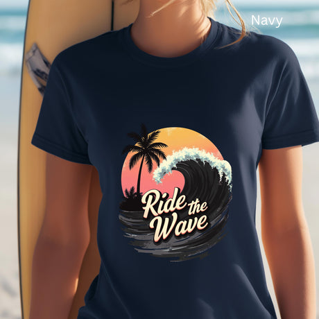 Navy t-shirt with 'Ride the Wave' graphic design held by a person with a surfboard.