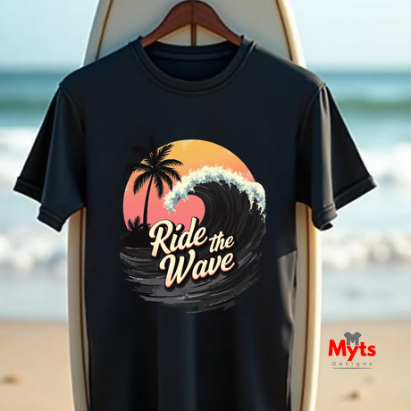 Black t-shirt with 'Ride the Wave' design on a surfboard against a beach background