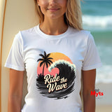 Woman wearing a white t-shirt with a 'Ride the Wave' design at the beach.