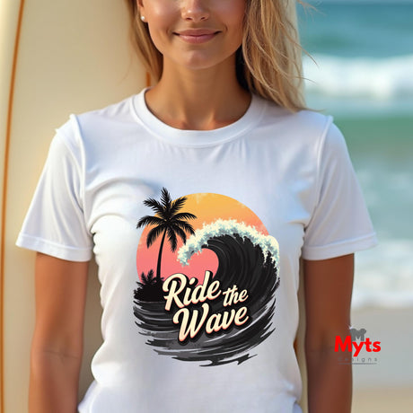 Woman wearing a white t-shirt with a 'Ride the Wave' design at the beach.