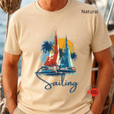 Beige t-shirt with sailboat graphic and 'Sailing' text, worn by a person.