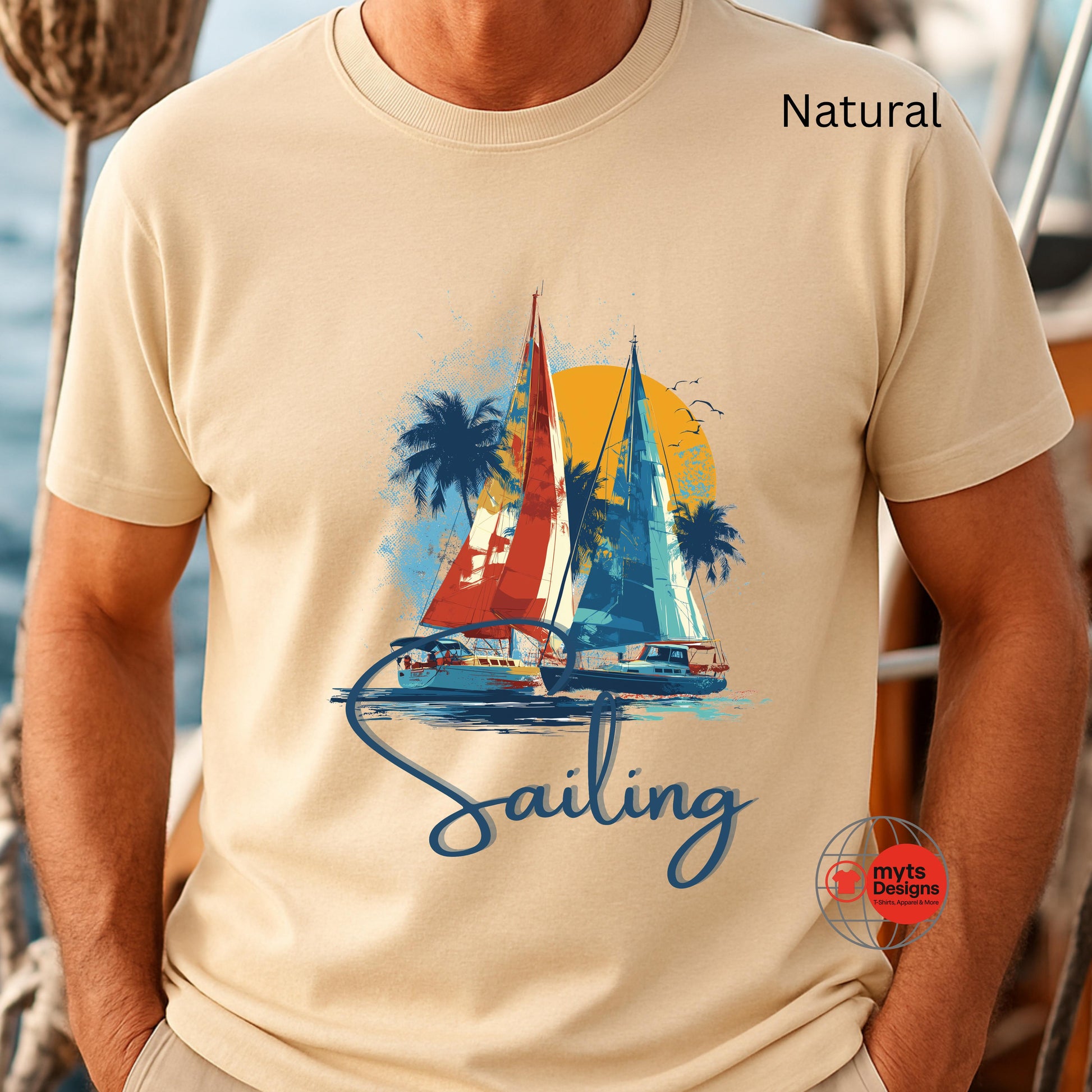 Beige t-shirt with sailboat graphic and 'Sailing' text, worn by a person.