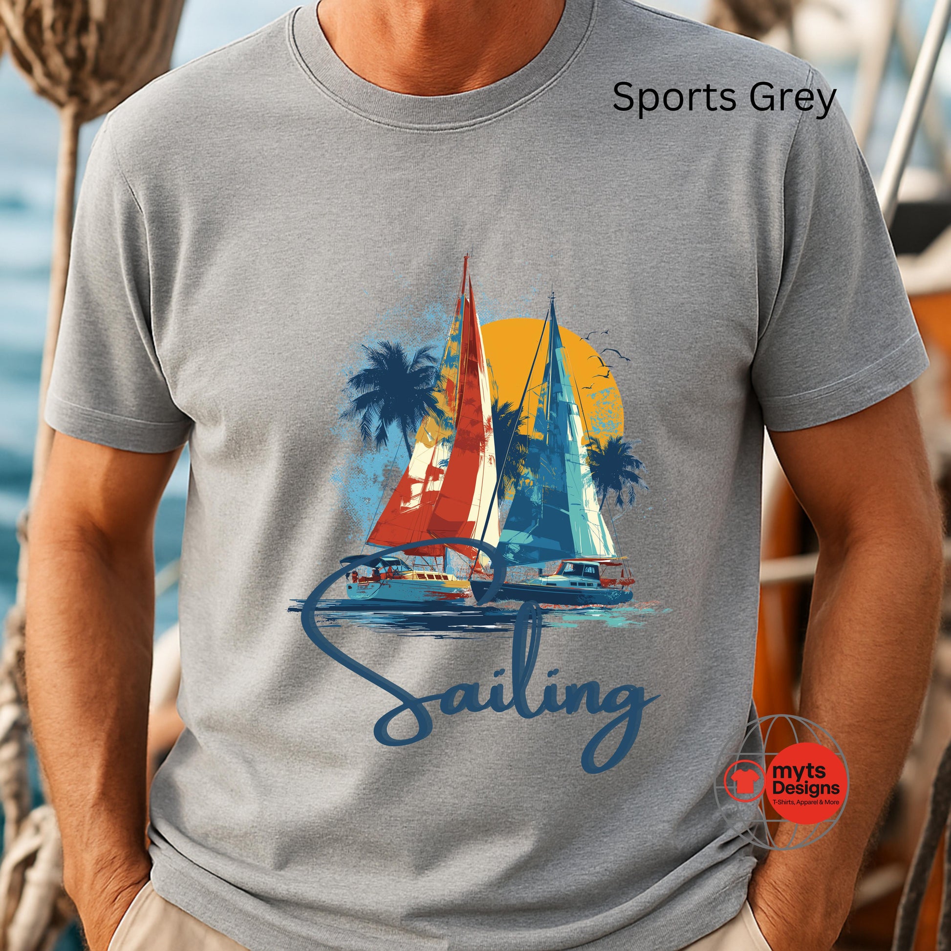 Gray t-shirt with a sailing graphic and 'Sports Grey' text on a blurred background.