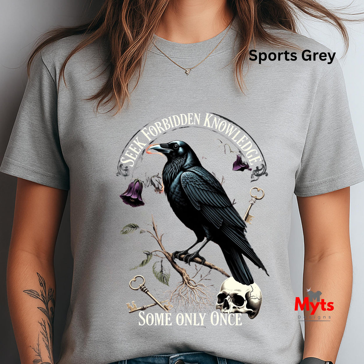 Gray t-shirt with a crow design and text, worn by a person.