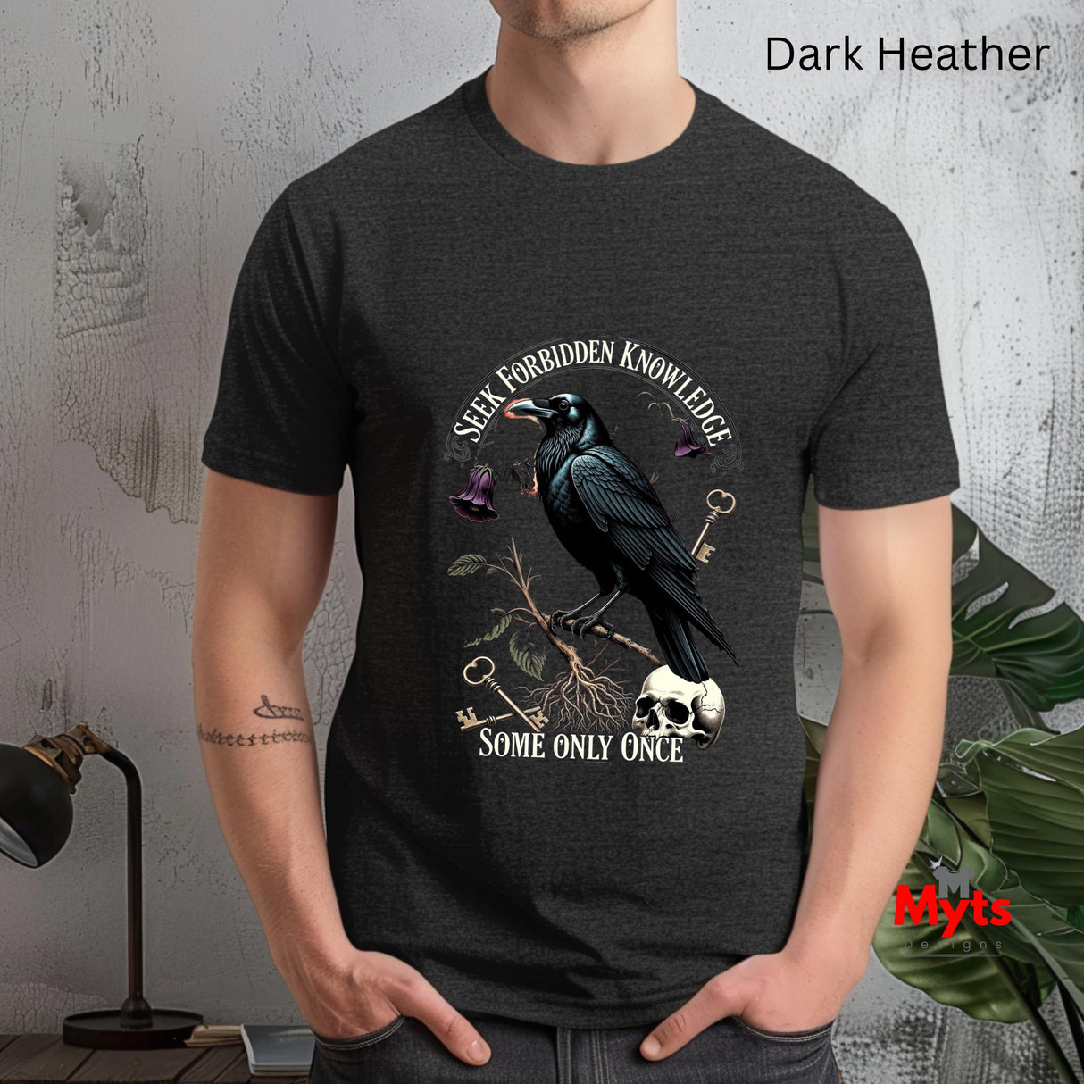 Person wearing a dark Heather t-shirt with a crow design and text.