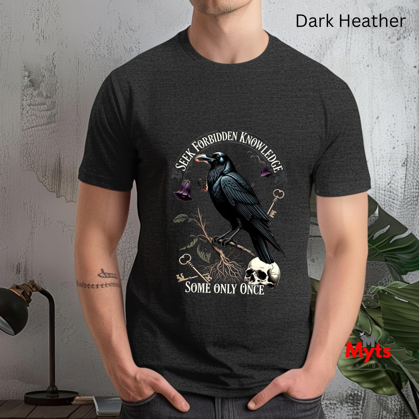 Person wearing a dark Heather t-shirt with a crow design and text.