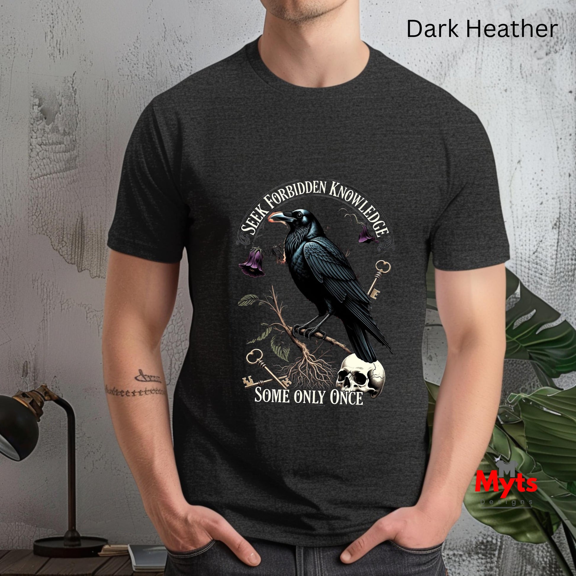 Person wearing a dark Heather t-shirt with a crow design and text.