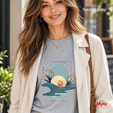 A_woman_wearing_a_cream_open_jacey_with_a_sports_grey_t-shirt_with_a_oceanic_design