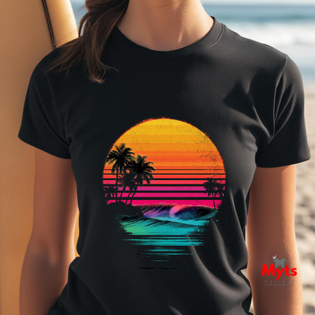 Black t-shirt with a colorful sunset and palm tree design worn by a person on a beach.