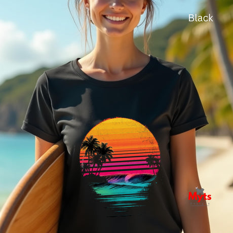 Person wearing a black t-shirt with a colorful sunset design on a beach