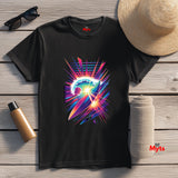 Black t-shirt with colorful abstract design on a wooden surface with accessories.
