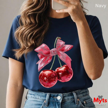 Person wearing a navy t-shirt with cherry and bow design, taking a selfie.