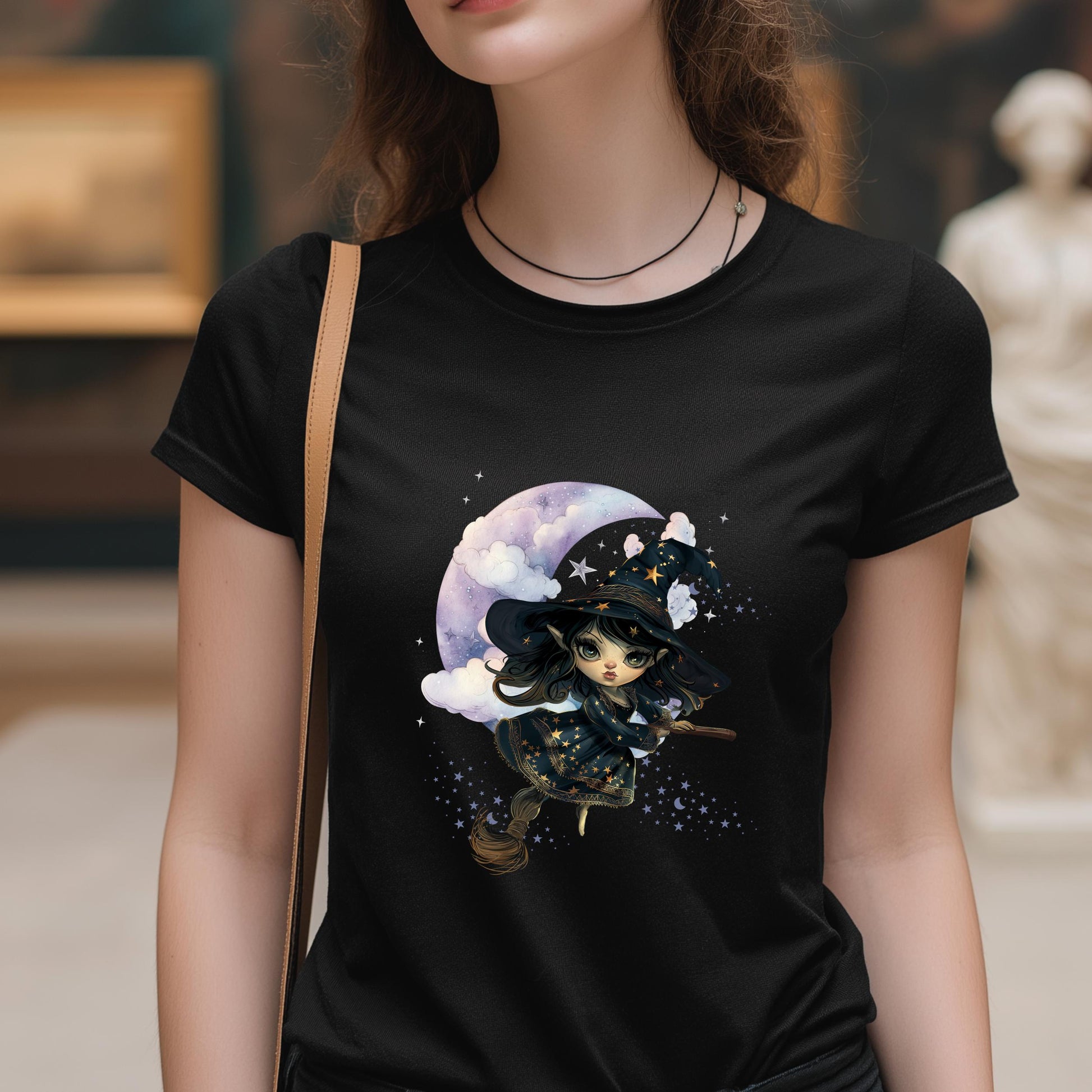 Person wearing a black t-shirt with a witch graphic design.