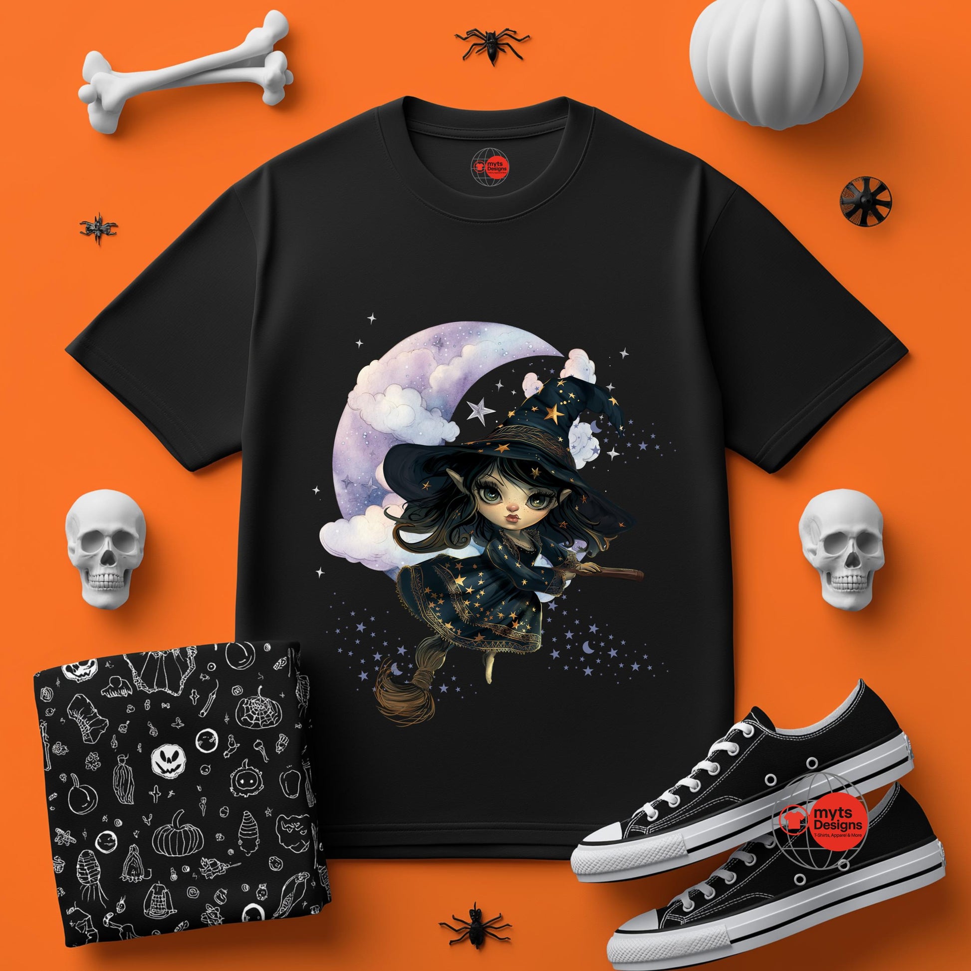 Black t-shirt with witch design on an orange background with Halloween-themed items.