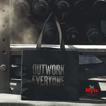 Black tote bag with 'OUTWORK EVERYONE' text in front of gym equipment, featuring the brand 'Myts'.