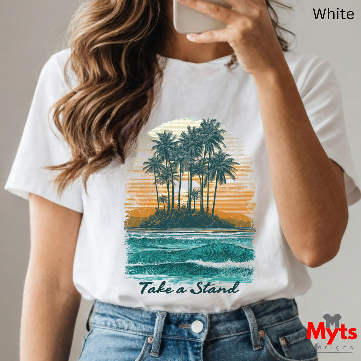 Person wearing a white t-shirt with a tropical island graphic and 'Take a Stand' text, holding a phone.