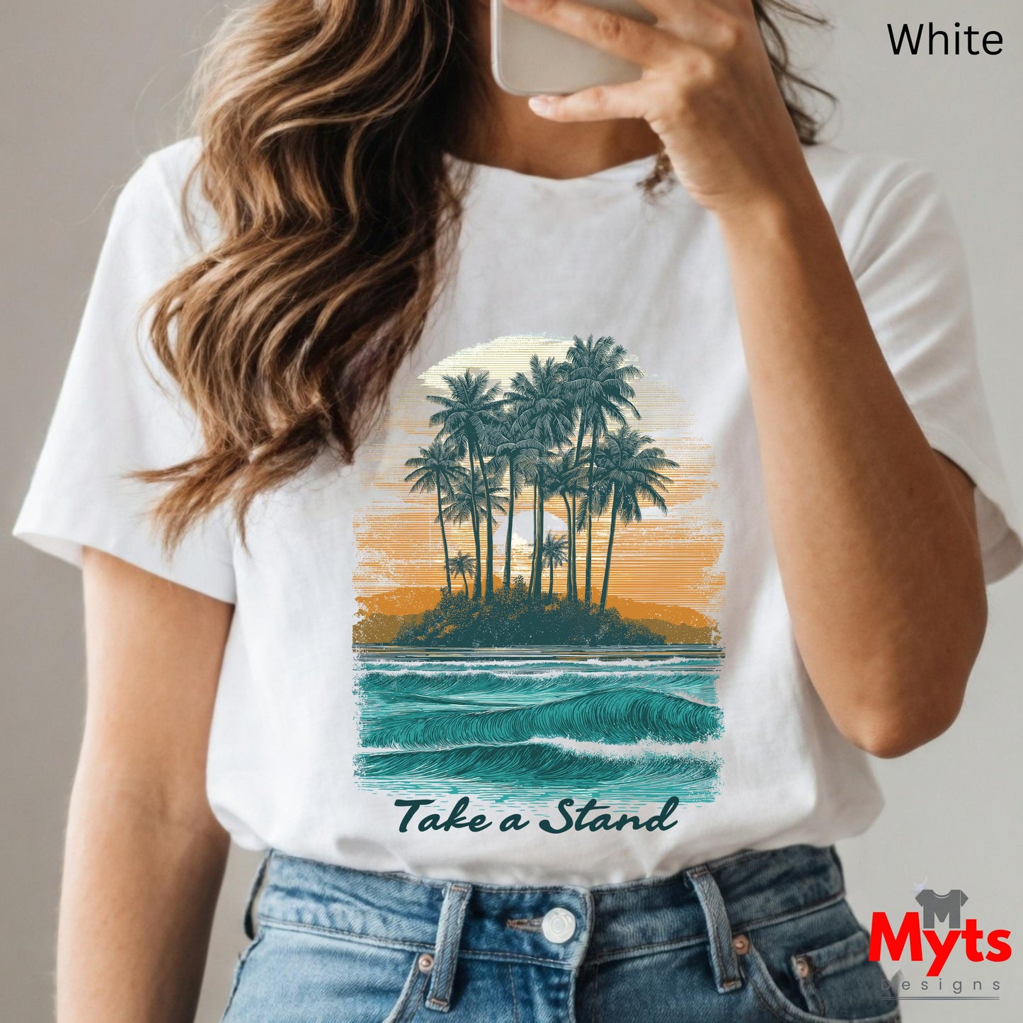 Person wearing a white t-shirt with a tropical island graphic and 'Take a Stand' text, holding a phone.
