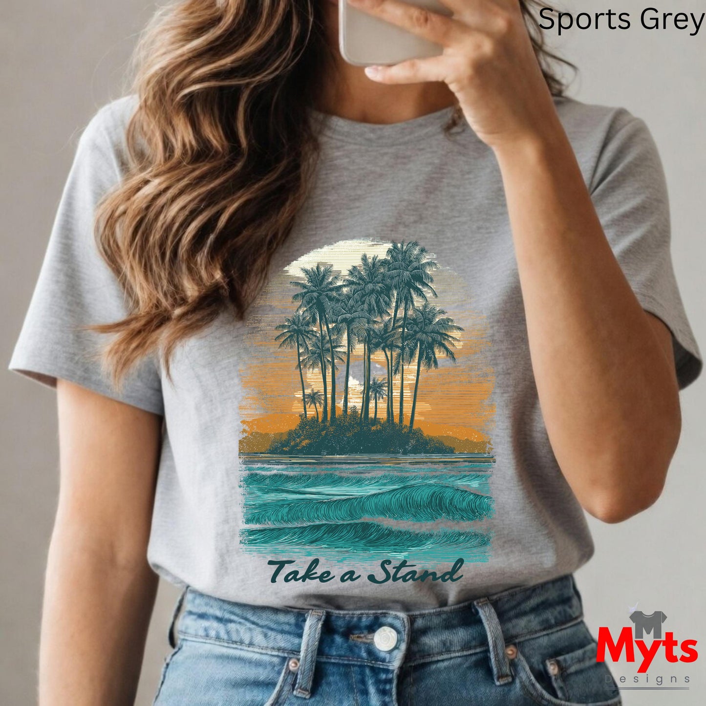 Person wearing a gray t-shirt with a tropical island design and 'Take a Stand' text, taking a selfie.